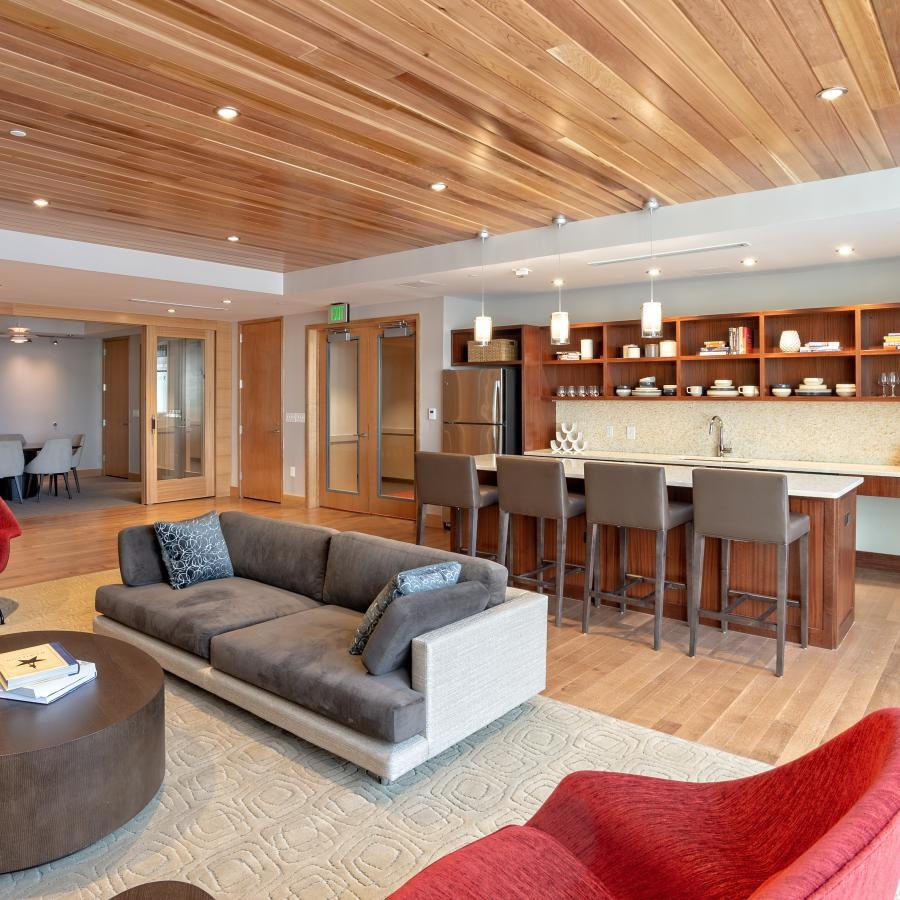 a large living room with a bar and a couch