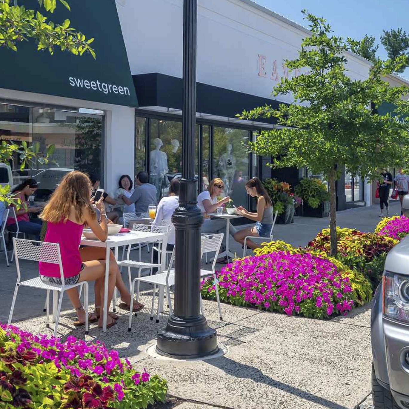 a group of people sitting at tables outside a building